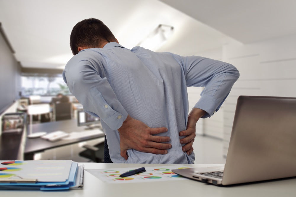 business man with back pain in an office