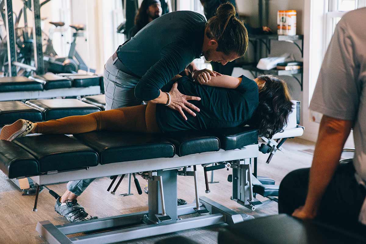 An image of Dr. Palmer performing chiropractic adjustments on a patient at Archetype Health's Homewood, AL location.