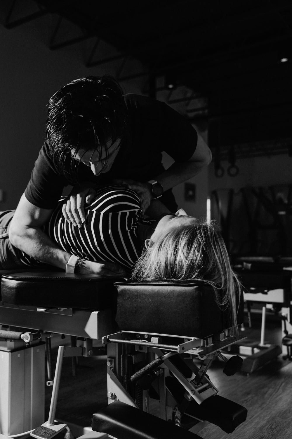 Dr. John Palmer performing chiropractic spinal djustment on a patient to relieve back pain.