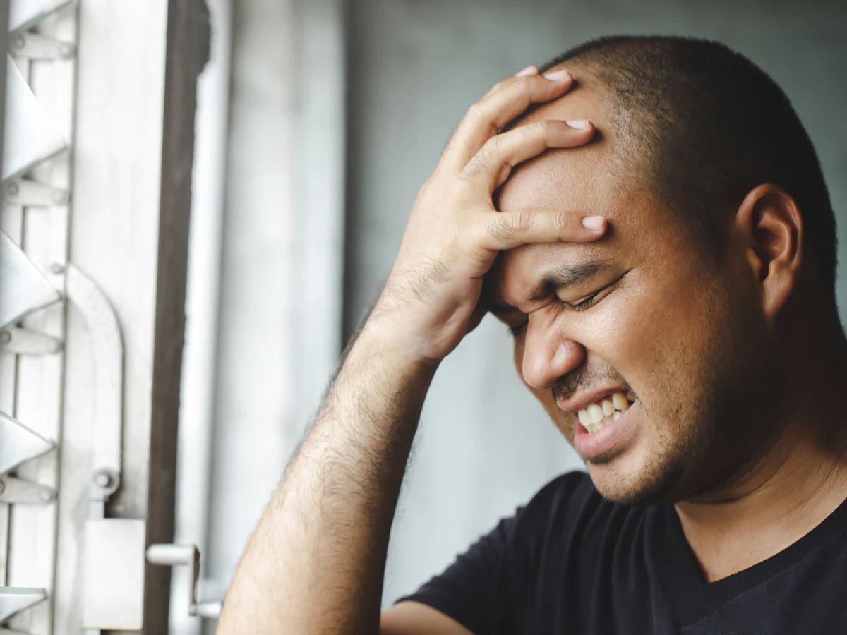 image of man experiencing a headache