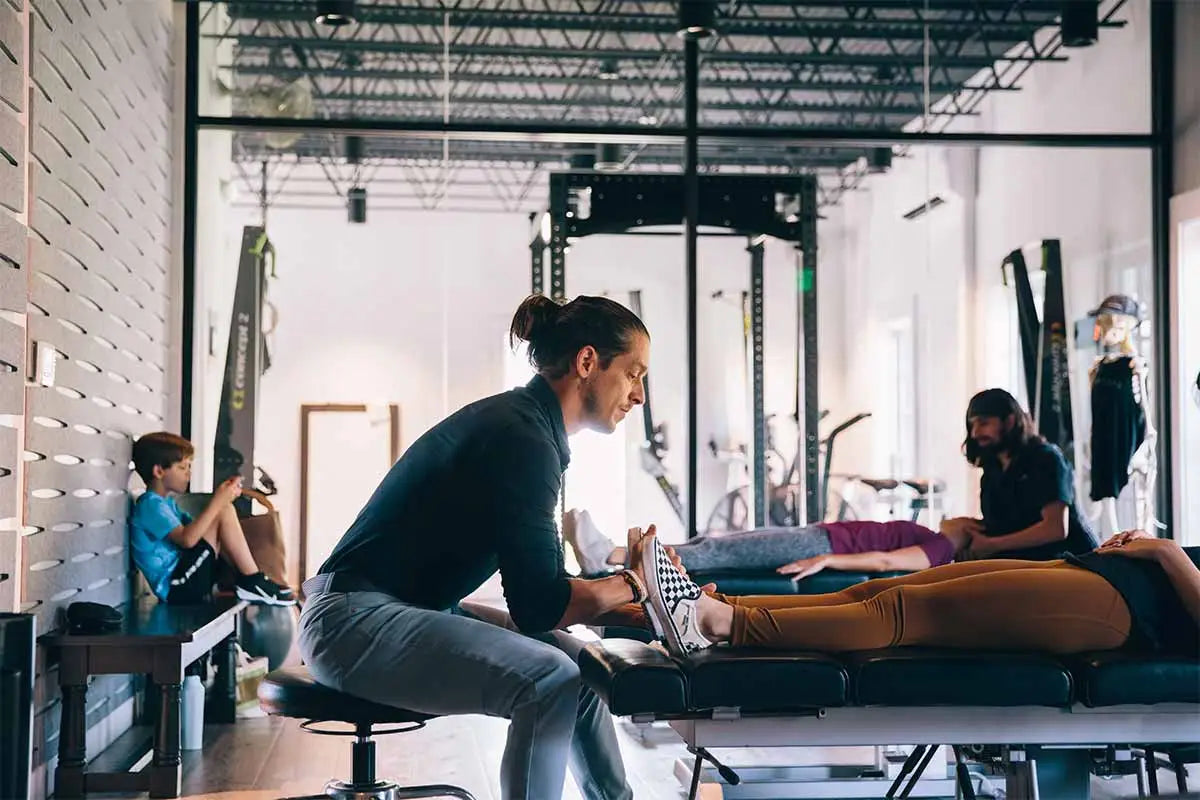 Image of practitioner performing muscle rehabilitation care on a patient